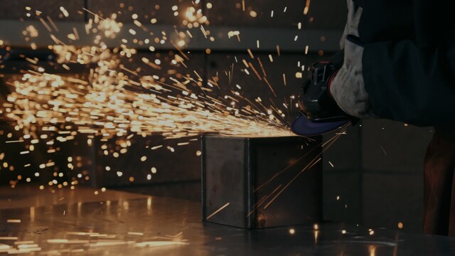 image of a person grinding a metal box
