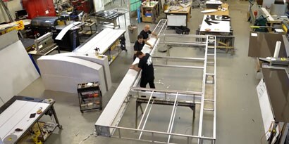 A group of people working on a metal frame