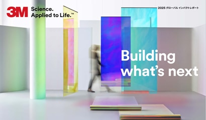 A person walking in a room with colorful glass panels
