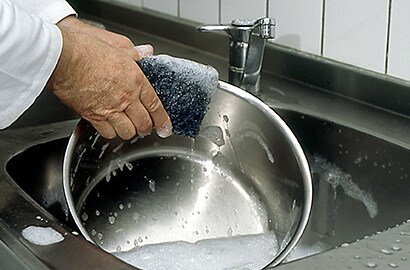 Cleaning pot in commercial kitchen