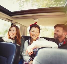 Full-width panoramic sunroof in car with three passengers in backseat