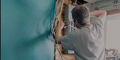Temflex application image of electrician working on residential junction box

