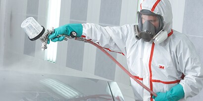 Man working outside on truck wearing PPE
