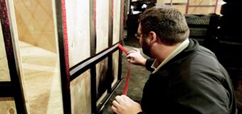 An image of a man unrolling a tape of 3M VHB Tape