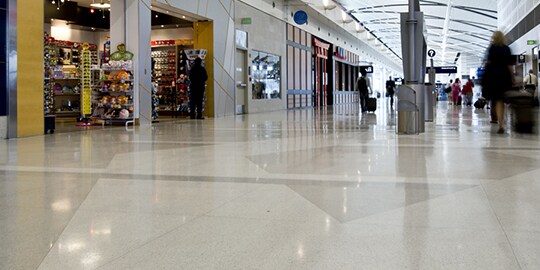 Interior of shopping mall with clean, shiny floors.
