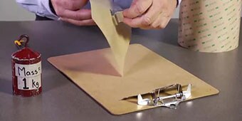 Video still of the demonstrator preparing to bond a metal part to a polypropylene slab
