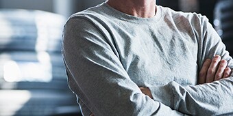 An image of a person with arms folded on his chest
