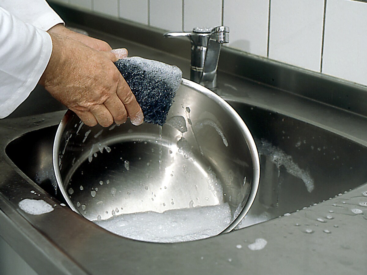 Cleaning pot in commercial kitchen

