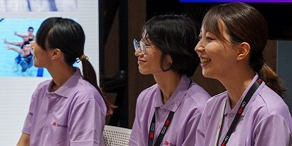A group of women in purple shirts
