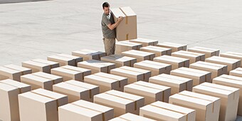 A man lining up boxes
