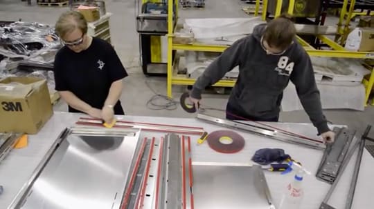 2 men working on a metal object