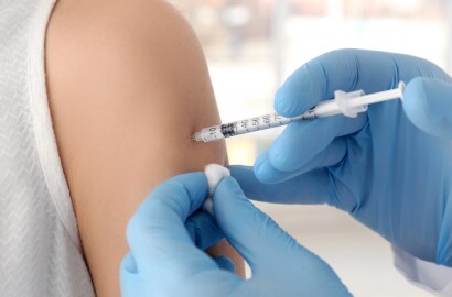 Healthcare worker administers vaccine into arm
