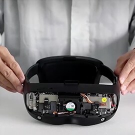 A person holding an AR/VR headset.