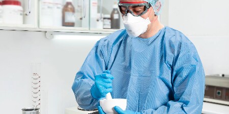 PAPRを装着して患者を介助している医療従事者
