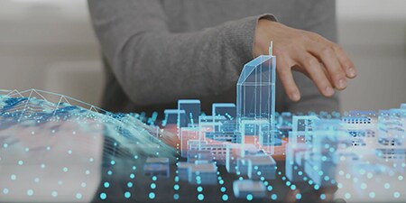 A person looking at a hologram of a city.
