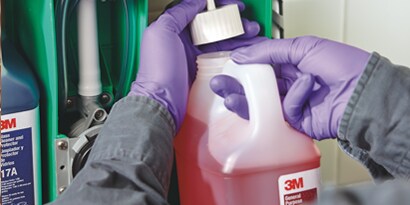 male service contractor filling a chemical management dispenser with 3M chemicals

