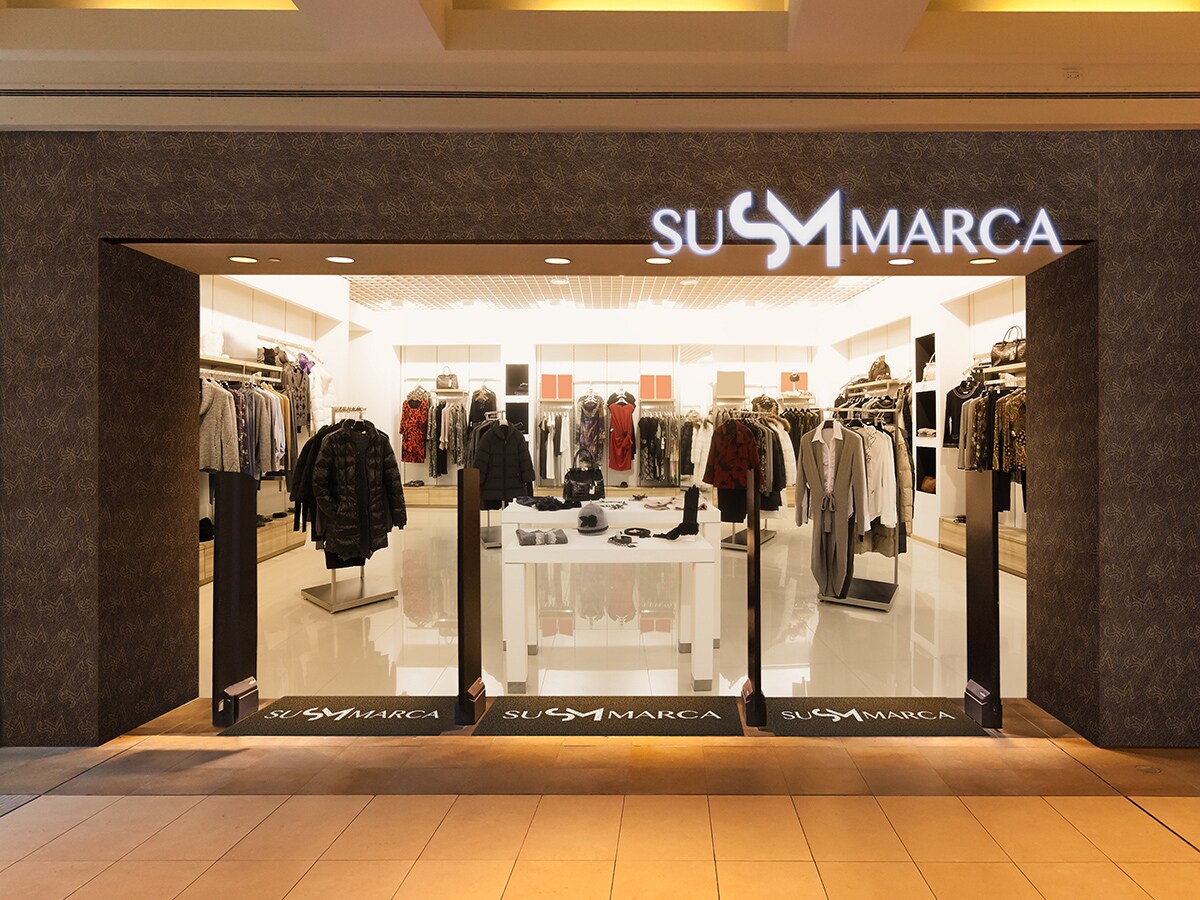 Retail clothing store with white exterior signage.
